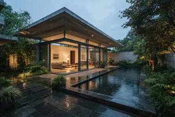 Cinematic contemporary courtyard house with a cantilevered concrete roof, warm glass-walled interiors, reflecting pool, tropical plants, and wet stone terraces in evening rain.