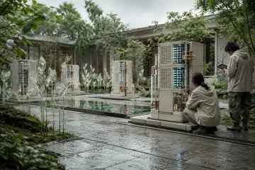 Landscape view of a rain-cooled ceramic computing garden with modular processing towers, reflective water channels, sensor plants, and two anonymous technicians.
