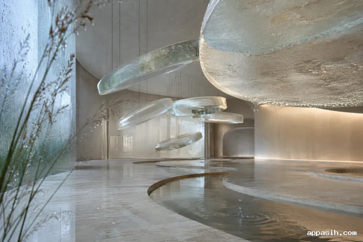 Detailed abstract limestone chamber viewed from a closer three-quarter angle with suspended frosted mineral-glass halos, floating droplets, condensation, and a delicate ripple in a circular water channel.